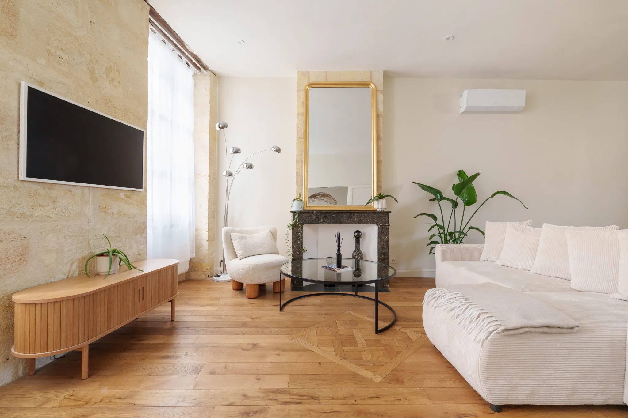Salon aux couleurs écru et miel, matières chaleureuses, parquet, velour